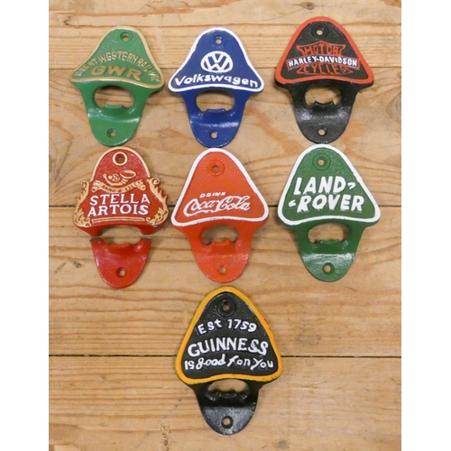 240 - A collection of various advertising cast iron bottle openers