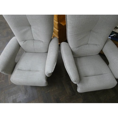 254 - A pair of modern Himolla swivel reclining easy chairs in a pale grey chenille