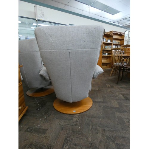 254 - A pair of modern Himolla swivel reclining easy chairs in a pale grey chenille