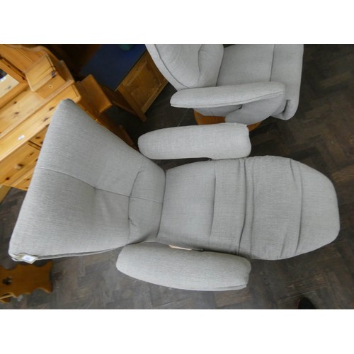 254 - A pair of modern Himolla swivel reclining easy chairs in a pale grey chenille