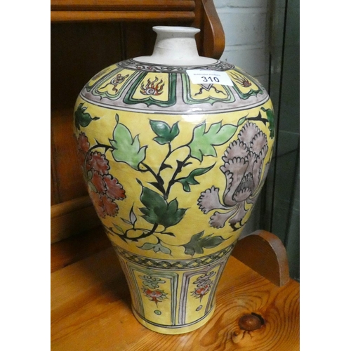 A large floral decorated bottle shaped vase