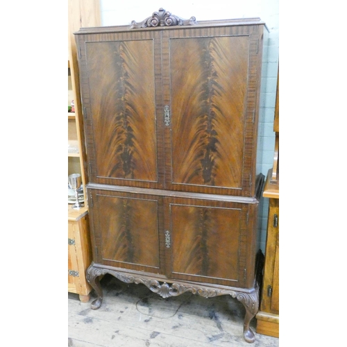 36 - A flame mahogany cocktail cabinet on carved apron and cabriole legs