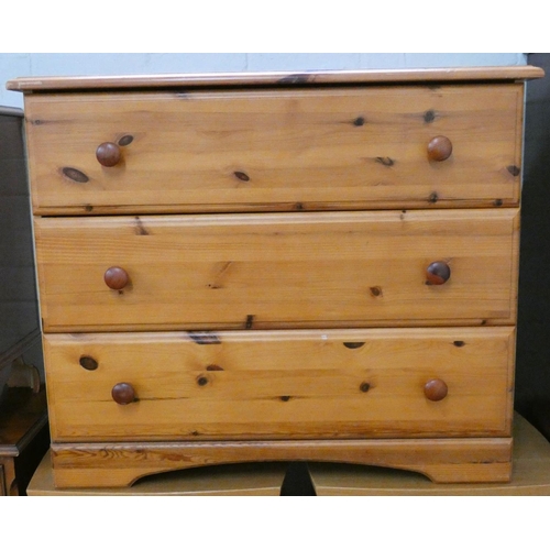 83 - A varnished pine chest of three long drawers
