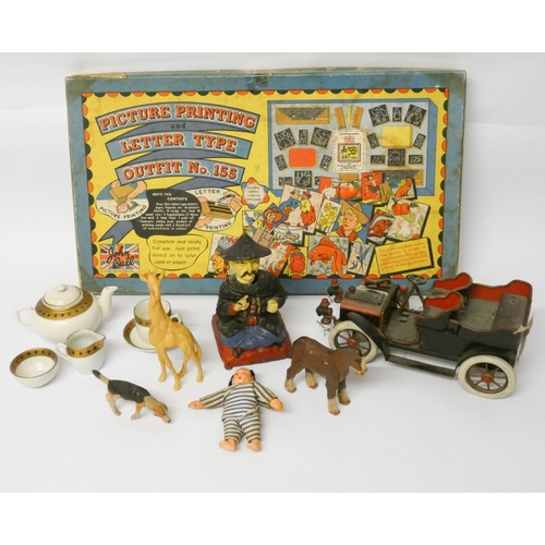 504 - A model of a vintage car, lead painted Chinese figurine, small dolls, wooden toys and a dolls tea se... 