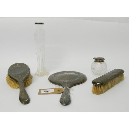 597 - A hallmarked silver backed hairbrush dressing table set, comprising hand mirror and two brushes and ... 