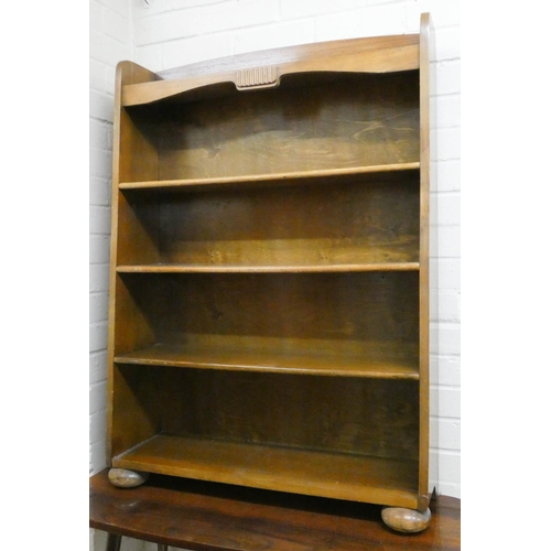 27 - A low four tier open bookcase and a long mahogany coffee table