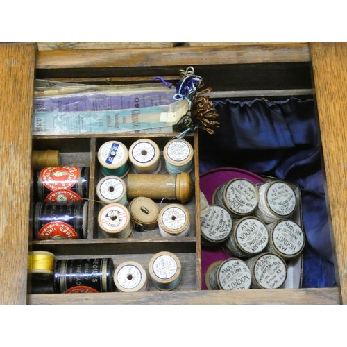 46 - An oak workbox with a large quantity of assorted cottons etc