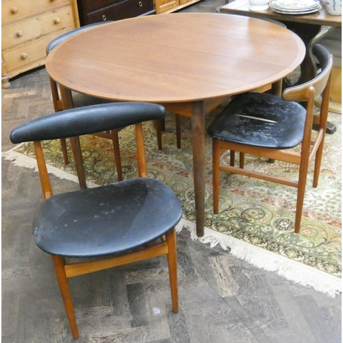 64 - A Danex Danish teak circular dining table and four matching chairs (one seat has a split through uph... 