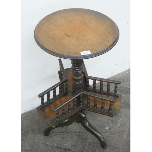 144 - A late Victorian mahogany wine table with book shelf under on tripod base