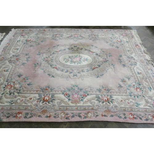 145 - A large pink Chinese floral embossed carpet, 2.4 X 3.4 metres