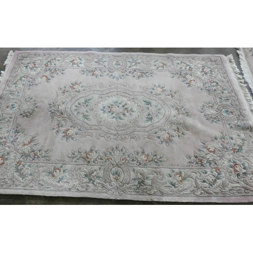 146 - A smaller pink floral embossed Chinese carpet 1.8 m x 2.8 metres