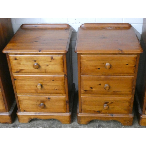 210 - Varnished pine pair of three drawer bedside cabinets