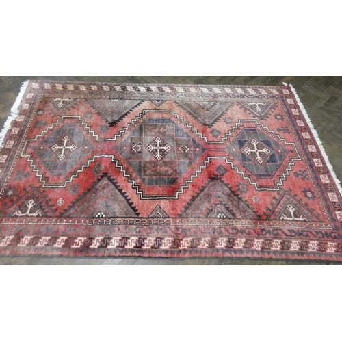 215 - Red Persian design wool long pile rug, 1.8 metres x 2.8 metres