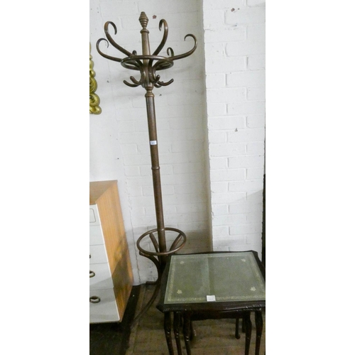 203 - Nest of three mahogany coffee tables with inset green leather tops and a bentwood hat and coat stand