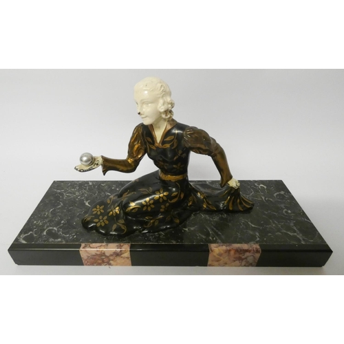 261 - An Art Deco bronze lady figure seated in an evening dress holding an orb on a coloured marble rectan... 