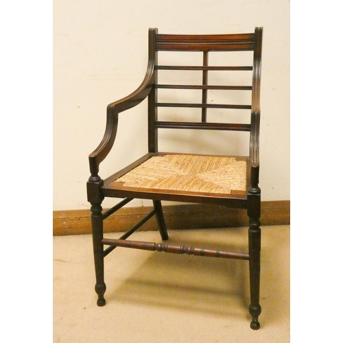 245 - An Edwardian mahogany framed elbow chair with rush seat
