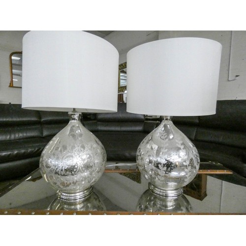 88 - An impressive pair of mercury glass modern table lamps with cream silk drum shades, each lamp stands... 