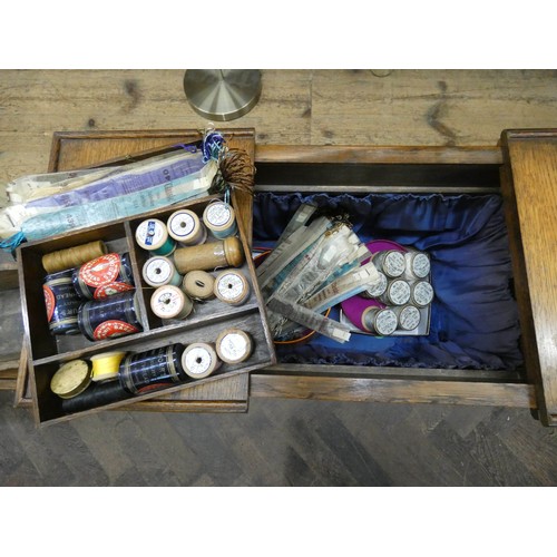 46 - An oak workbox with a large quantity of assorted cottons etc