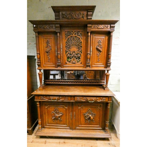 306 - A French Henri II carved oak buffet cabinet, with well carved panels and lattice glazed doors to the... 