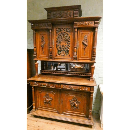 306 - A French Henri II carved oak buffet cabinet, with well carved panels and lattice glazed doors to the... 