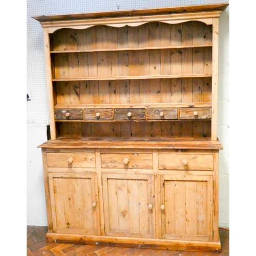 359 - A Victorian stripped pine dresser with shelf and spice drawer back, three drawers and cupboards unde... 