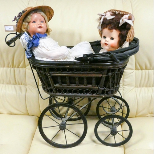 782 - A vintage style dolls pram and two old English dollies