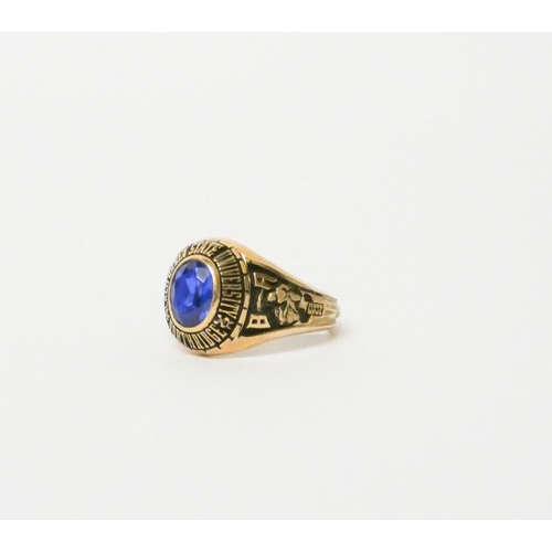 701 - American College ring, set with a faceted blue stone on 10K gold band. Ring size M