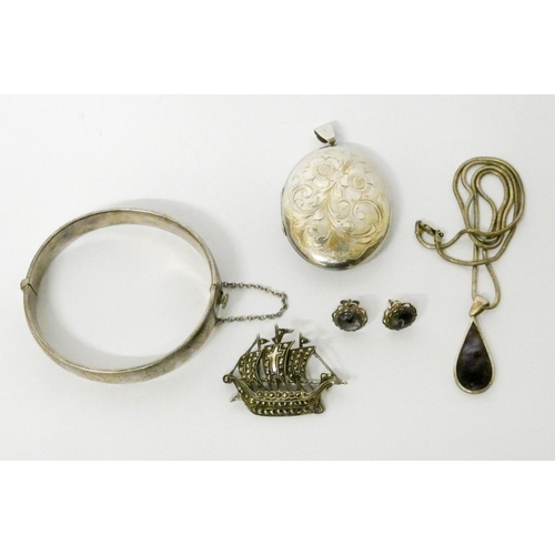 582 - A silver bangle, oval locket, marcasite galleon brooch etc