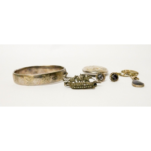 582 - A silver bangle, oval locket, marcasite galleon brooch etc
