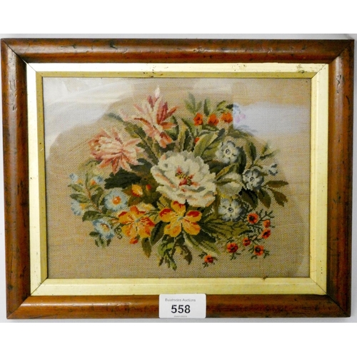 558 - A small Victorian petit point embroidery floral panel, in walnut and gilt frame. Size 23 cms x 28 cm... 