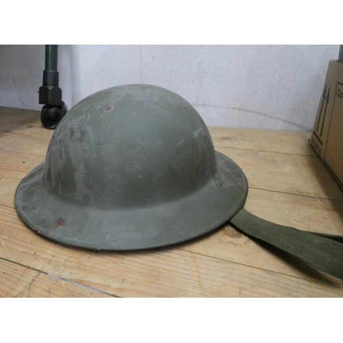 921 - Three assorted army helmets with some camouflage hats, ground sheet, stab vest, telescopic sight and... 