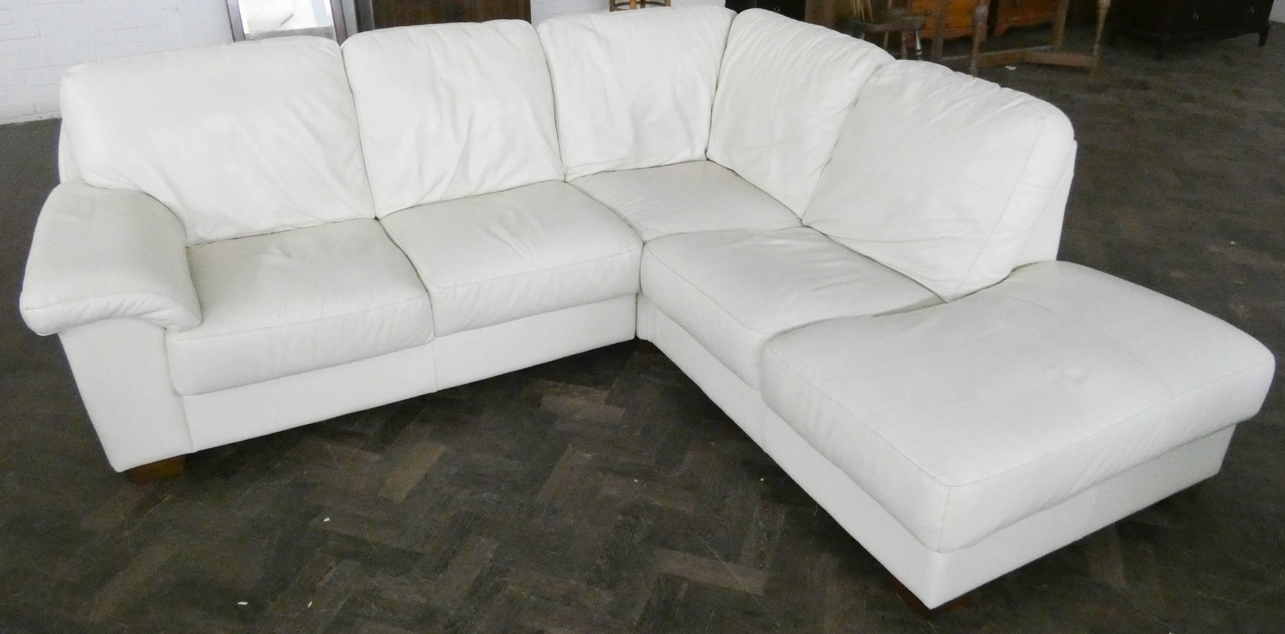A cream faux leather corner settee unit