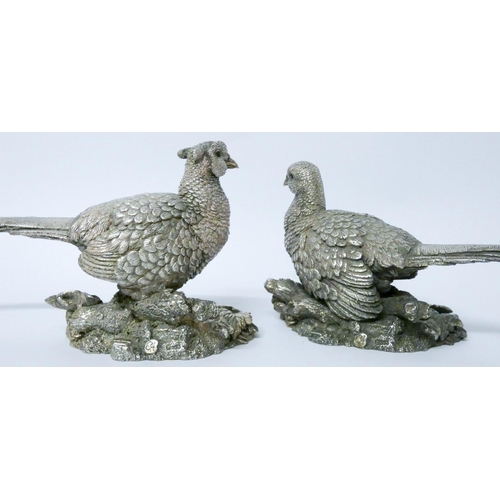 611 - Pair of Country Artists contemporary silver covered models of a pair of pheasants, with glass eyes, ...