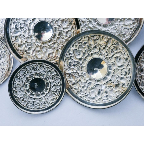 619 - A set of 12 Chinese white metal embossed dish or pot lids, all marked 925 MD, six size 11 cms diamet...