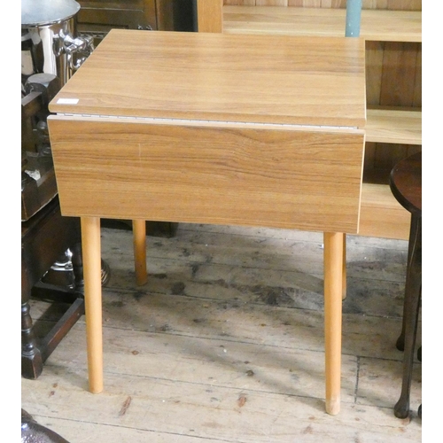 27 - A small wood effect melamine topped drop leaf kitchen table