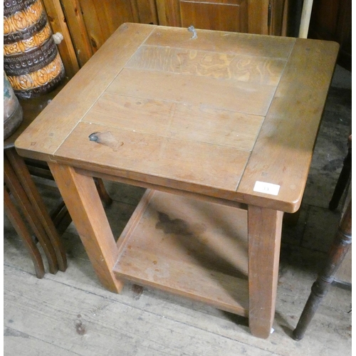 33 - A chunky oak two tier occasional table...