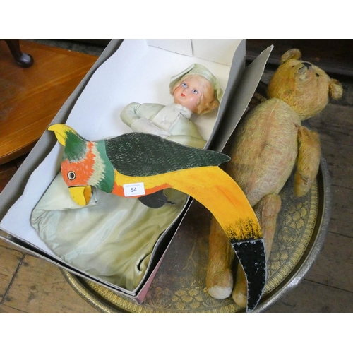 54 - An old plush teddy bear, dressed doll and a swinging parrot...