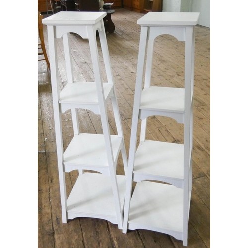 6 - A pair of white four tier square shelving units