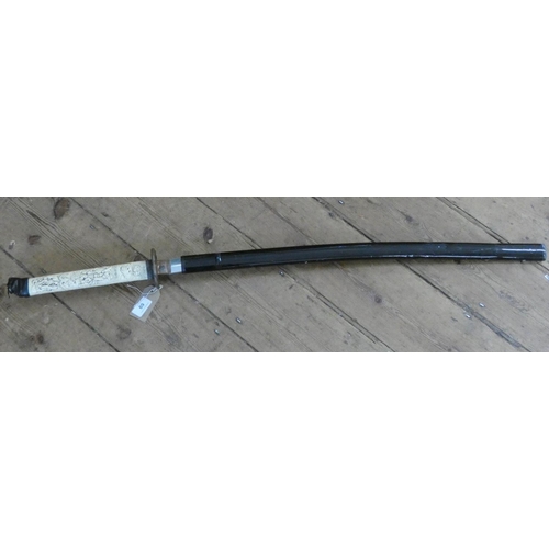 69 - A reproduction Japanese sword in scabbard with faux ivory handle