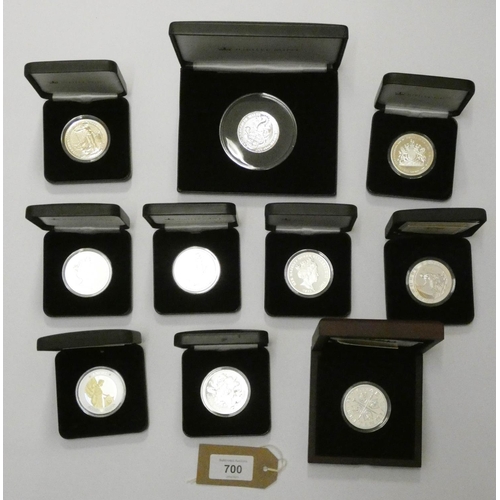 700 - A collection of 10 silver crown sized coins to include Britannia's, 75th anniversary of the Battle o... 