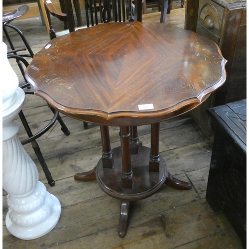 107 - A two tier mahogany occasional table with pie crust edge