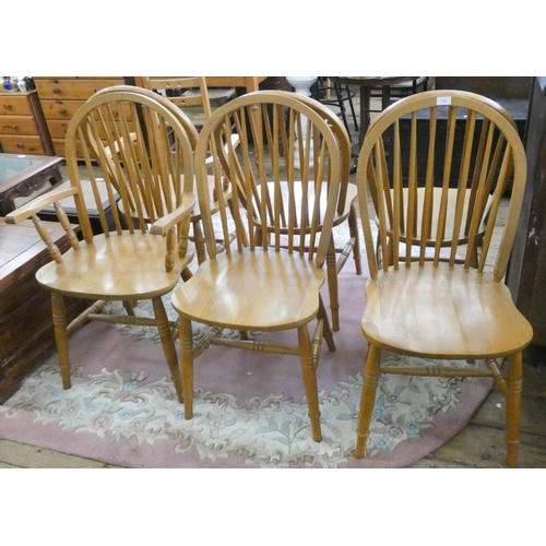 120 - A set of six beech spindle back dining chairs with panel seats and a pair of matching carver chairs