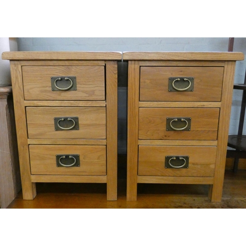 11 - A pair of modern good quality light oak bedside chests each fitted three drawers...