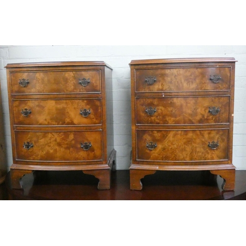 41 - A pair of small walnut bow fronted bedside chests each fitted three drawers...