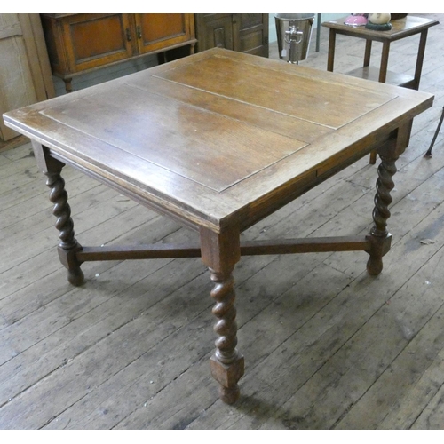 97 - An oak drawer leaf dining table on barley twist legs, 3'6