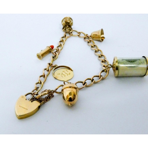 658 - 9ct yellow gold charm bracelet set numerous charms, including vintage £1 note. Gross weight 18.9 gra...