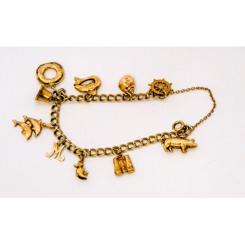 659 - 9ct yellow gold charm bracelet set numerous charms, including nautical motifs. Gross weight 13.3 gra...