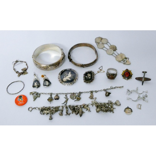 661 - Silver jewellery - two hinged bangles, ring, two charm bracelets, three penny bit bracelet, Siamese ... 