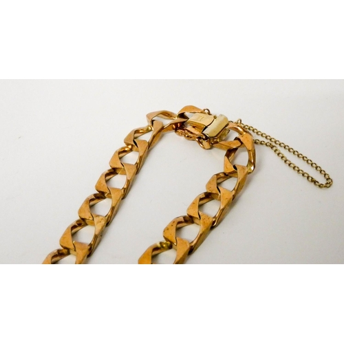 688 - 9ct gold flattened curb link chain gents bracelet, with clasp and safety chain fastening. Gross weig... 