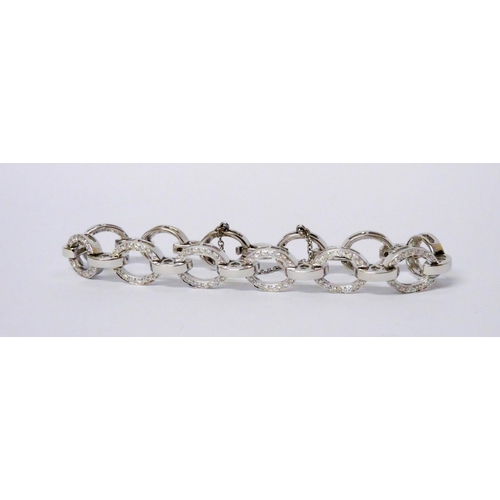 716 - A modern diamond open link bracelet, the oval 18ct white gold links channel set with diamonds, invis... 